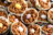 A close-up of chocolate cereal treats in paper liners, some with small candy eggs.